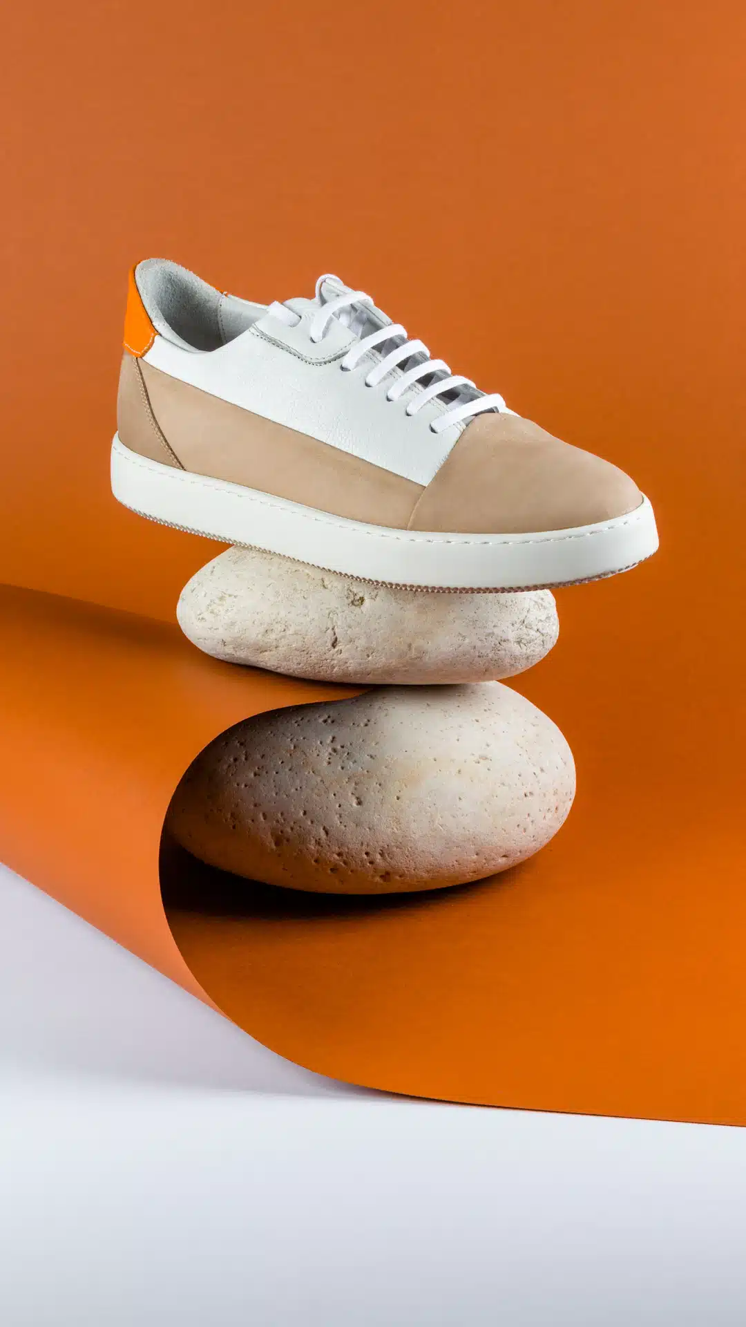 a pair of shoes sitting on top of a rock
