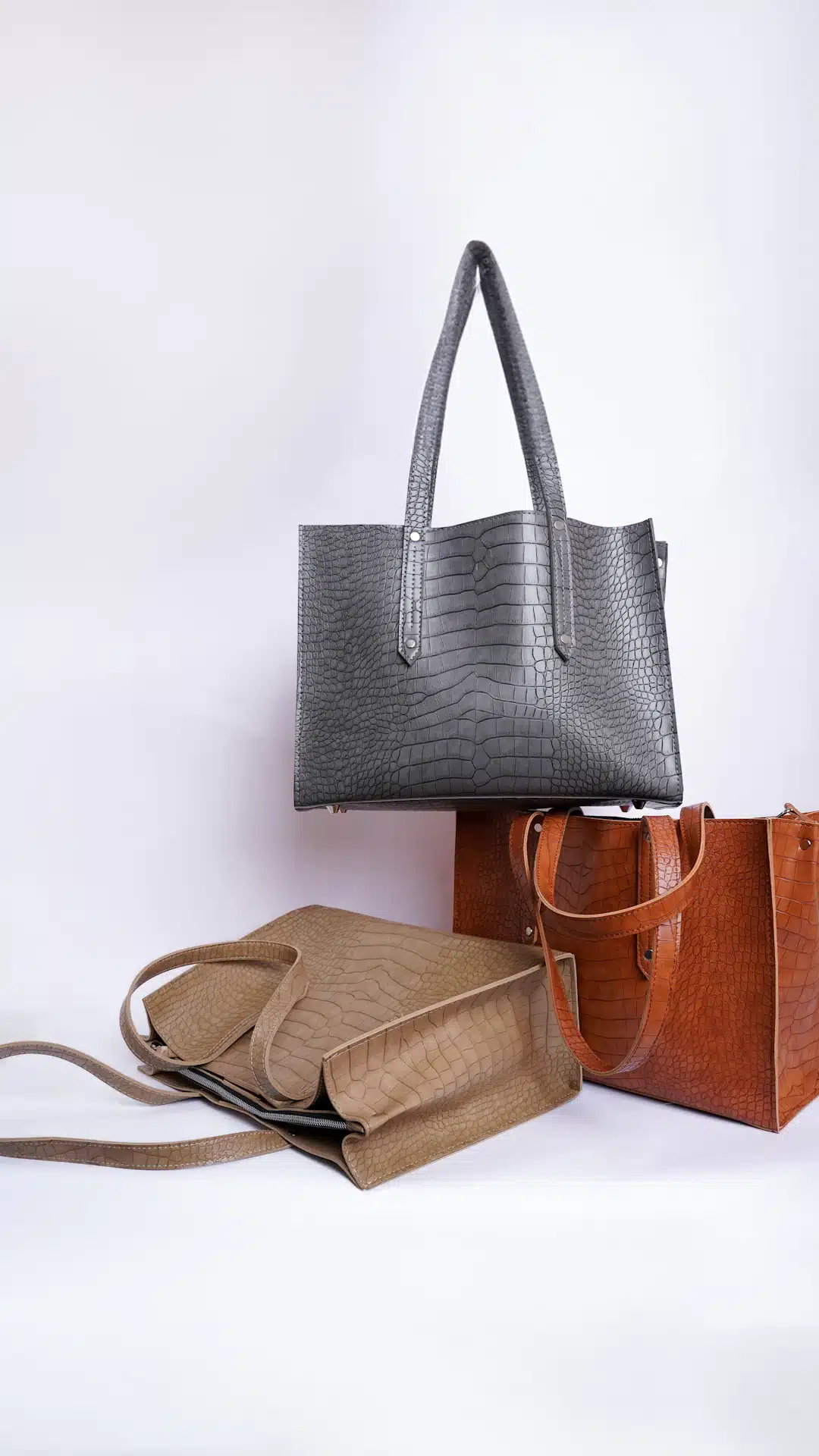 three different types of purses on a white background
